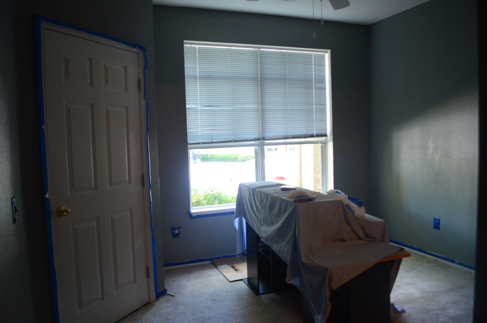 Baby room during paint progress, with tape.