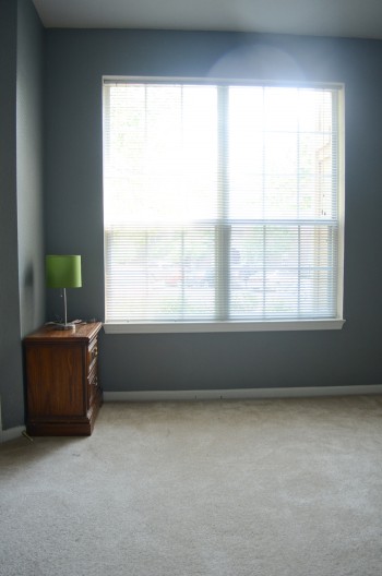 The grey walls by the window in the baby room